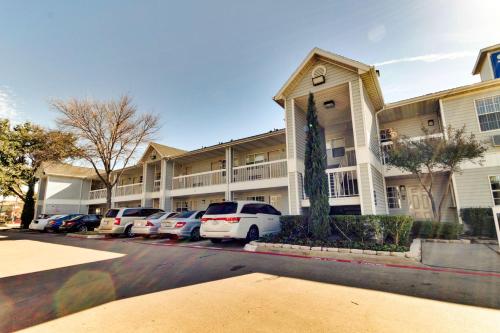 a building with cars parked in a parking lot at Studio 6-Dallas, TX - Garland - Northeast in Richardson