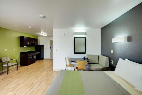 a room with a bed and a living room at Studio 6-Sweetwater, TX in Sweetwater