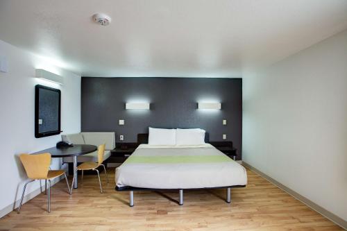 a bedroom with a bed and a table and chairs at Studio 6-Sweetwater, TX in Sweetwater