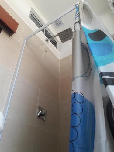 a shower in a bathroom with a shower head at Onkel Inn Wagon Sleepbox Uyuni in Uyuni