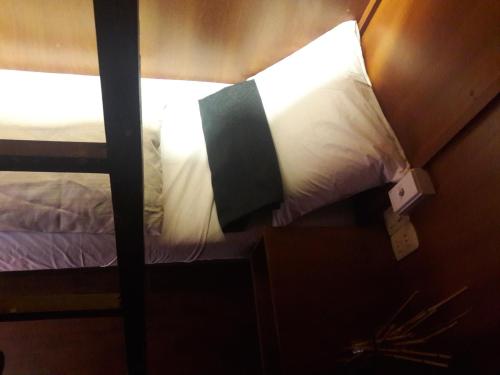 a bedroom with a bunk bed with a light on it at Onkel Inn Wagon Sleepbox Uyuni in Uyuni