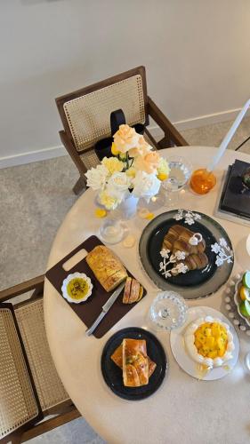 a table with plates of food on top of it at Rivi Retreat - Brand New Luxury & Central in Sydney