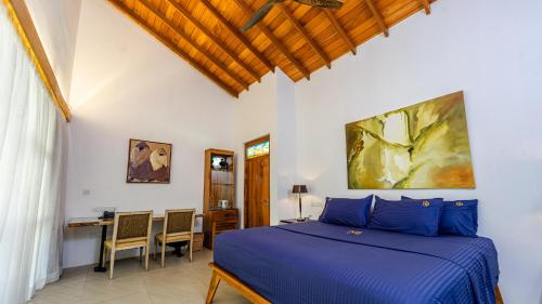 a bedroom with a blue bed and a desk at Villa Blue Lotus Katunayake in Katunayake