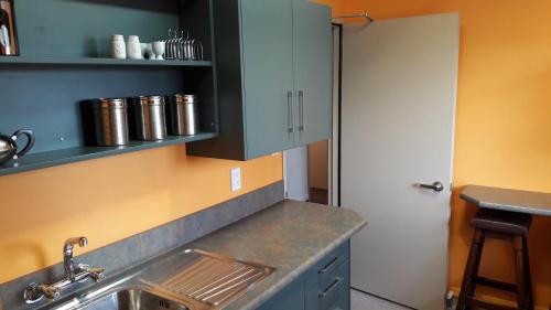 a kitchen with a sink and a white door at Serenity Motels in Pleasant Point