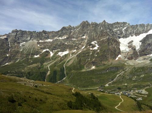 a mountain range with a village in front of it at Aux Pieds du Roi - Suite & Spa in Breuil-Cervinia