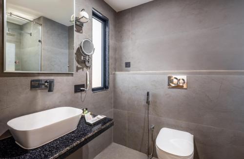a bathroom with a sink and a toilet and a mirror at Zone Connect by The Park Patna 
