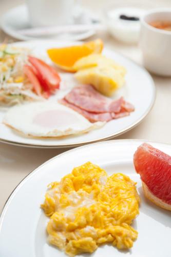 two plates of breakfast food on a table at Hotel Yassa in Mihara
