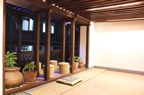 a room with potted plants on a balcony at Hiranya Guest House in Pātan