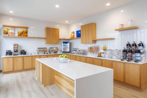 a large kitchen with wooden cabinets and a white counter top at Comfort Inn & Suites Newark Liberty International Airport in Newark