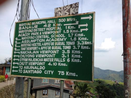 a sign on the side of a mountain at Mayoyao View Inn in Banaue