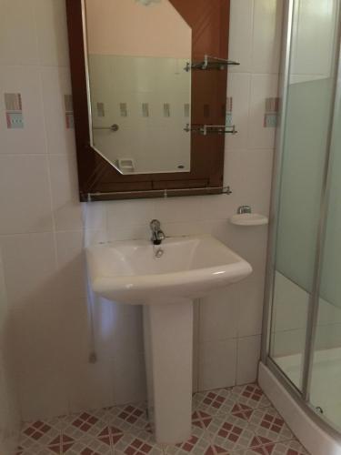 a bathroom with a sink and a mirror at Mayoyao View Inn in Banaue