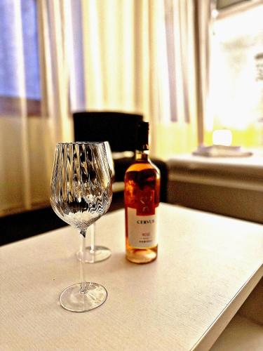a bottle of alcohol next to a wine glass at Sibiutiful - Ultracentral in Sibiu