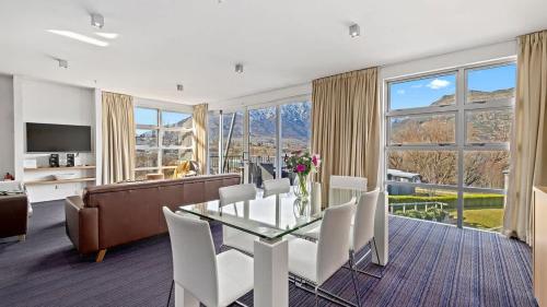 a living room with a table and chairs and a couch at Marina Quarters 406B in Queenstown