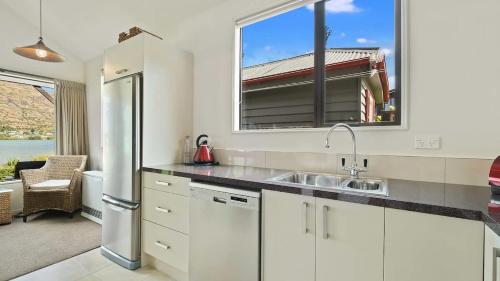 a kitchen with a sink and a window at Couple’s Retreat in Queenstown