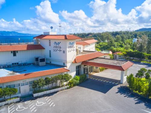 an overhead view of a building with a parking lot at Miyuki Hamabaru Resort in Onna