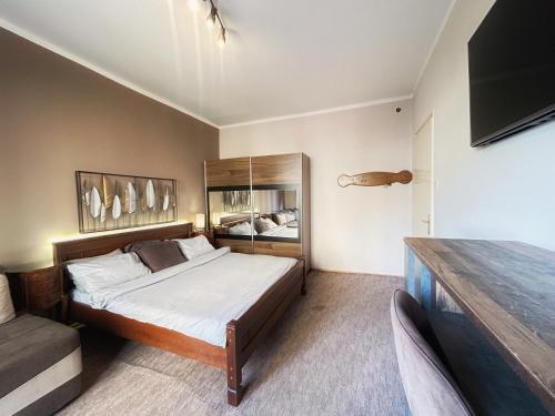 a bedroom with a bed and a television in it at Apartment Centar in Podgorica
