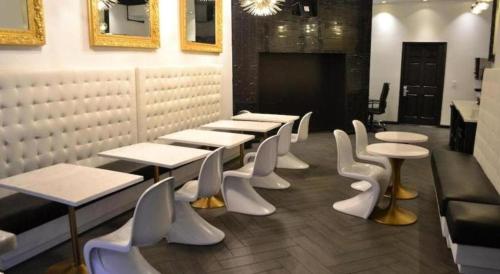 a row of tables and white chairs in a restaurant at Adante Hotel, a C-Two Hotel in San Francisco