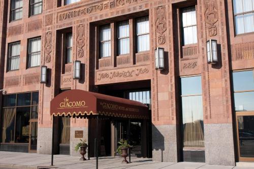 a large brick building with a sign in front of it at The Giacomo, an Ascend Collection Hotel in Niagara Falls