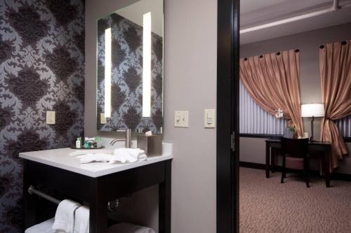 a bathroom with a sink and a mirror at The Giacomo, an Ascend Collection Hotel in Niagara Falls
