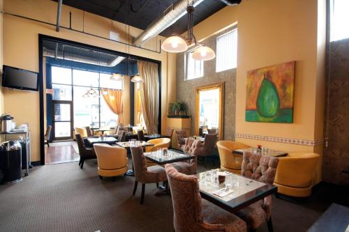a restaurant with tables and chairs and a large window at The Giacomo, an Ascend Collection Hotel in Niagara Falls
