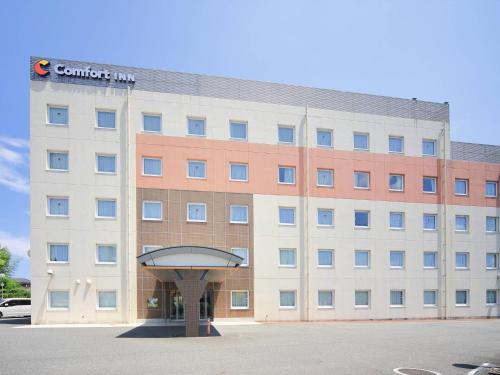 a building with a sign on the front of it at Comfort Inn Munakata in Munakata