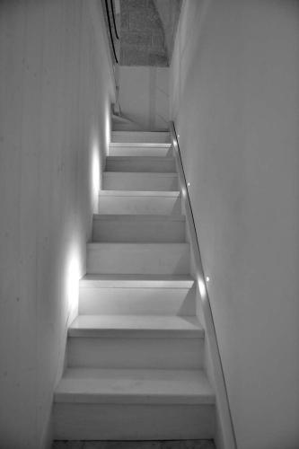 a stairway with white stairs with lights on it at Palazzo Kapece in Monopoli