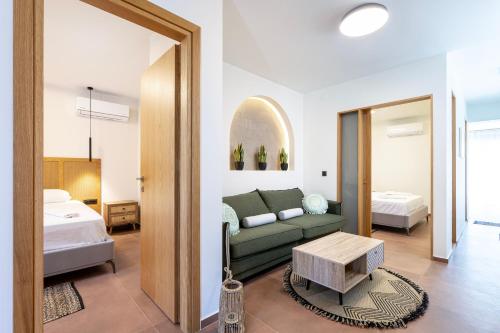 a living room with a couch and a bed at INFINITY PREMIUM Villas in Kos Town