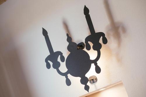 a shadow of a monkey on a wall at Hotel Baglio Catalano in Custonaci