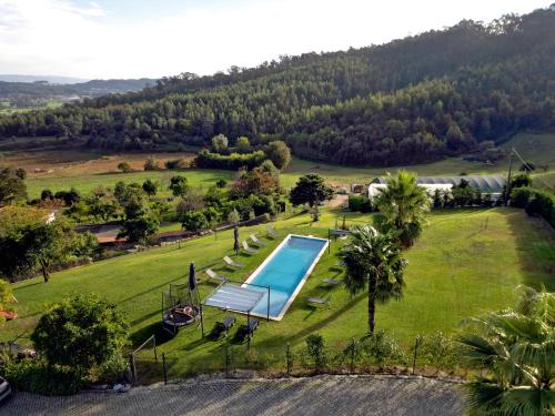 an aerial view of a swimming pool in a field at Casas de Fralães in Grimancelos