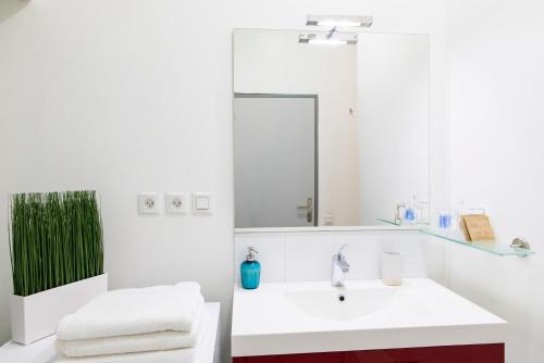 a bathroom with a sink and a mirror at Unsejouranantes- Loft Cassard in Nantes
