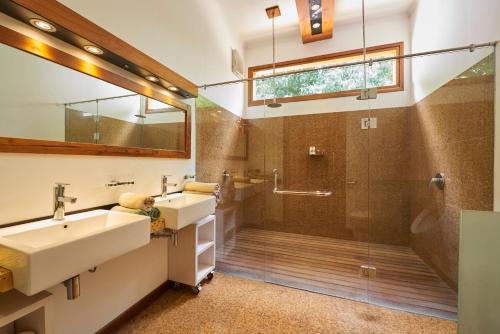 a bathroom with two sinks and a shower at Octopus Villas in Tejakula