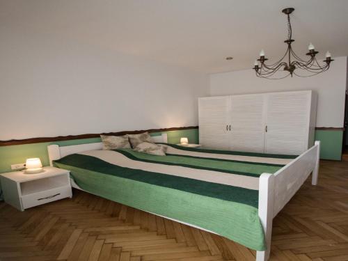 a bedroom with a large bed and a chandelier at Luxury Central apartment in Sibiu in Sibiu