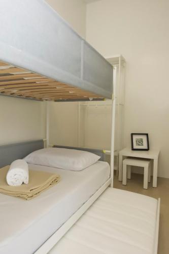 a bedroom with a bunk bed and a table at Verdant Villas in Kaybagal