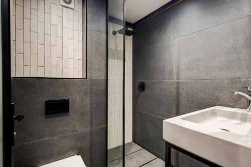 a bathroom with a sink and a shower at Hidden Gem Llandudno Studio in Llandudno