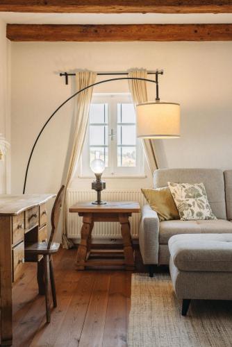a living room with a couch and a table at Das KRANACH 28 Weinberg Hideaways mit Whirlpool und Sauna in Fötschach