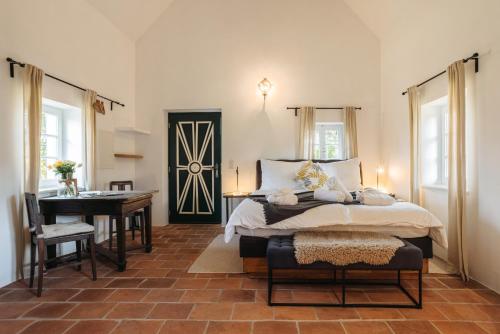 FötschachDas KRANACH 28的一间卧室，里面有一张床、一张桌子和一架钢琴