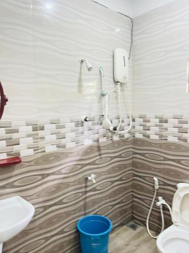 a bathroom with a shower and a sink and a toilet at J City Holidays Inn in Jaffna