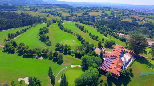 an aerial view of a house on a golf course at Oca Palacio De La Llorea Hotel & Spa in Deva