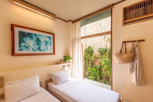 a room with two beds and a window at Tadhana Villa in General Luna