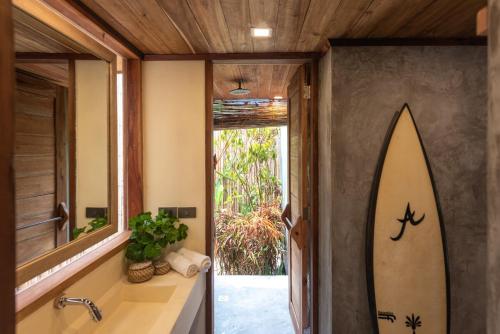 a bathroom with a surfboard painted on the wall at Tadhana Villa in General Luna