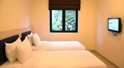 Postel nebo postele na pokoji v ubytování Sumi Hotel Mangga Besar
