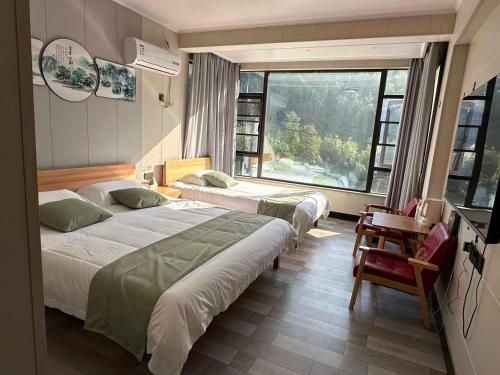 Postel nebo postele na pokoji v ubytování Tonglu Hemingge Homestay