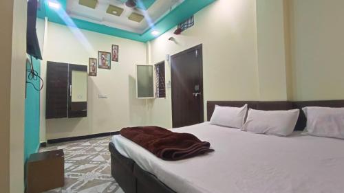 a bedroom with a bed with a blanket on it at Hotel Priyanshi Palace in Ujjain