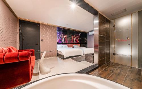 a bathroom with a tub and a bedroom at The Oreun Echae Hotel in Jeju