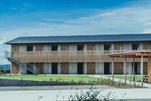 a large building with a black roof at SANU 2nd Home 館山1st in Tateyama