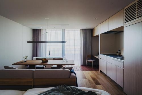 a living room with a table and a dining room at SANU 2nd Home 館山1st in Tateyama