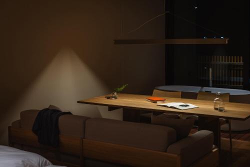 a living room with a table and a couch at SANU 2nd Home 館山1st in Tateyama