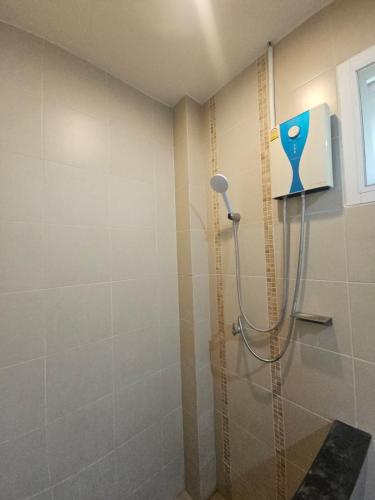 a shower with a shower head in a bathroom at Seaview Studio Jungle in Lamai