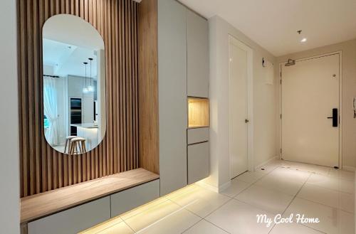 a hallway with a mirror and a dressing room at Onsen Suite Theme Park View in Ipoh