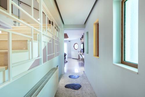 a hallway of a house with blue walls at INFINITY PREMIUM Villas in Kos Town